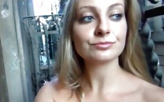 Pretty blondie plays with a sex toy on the balcony